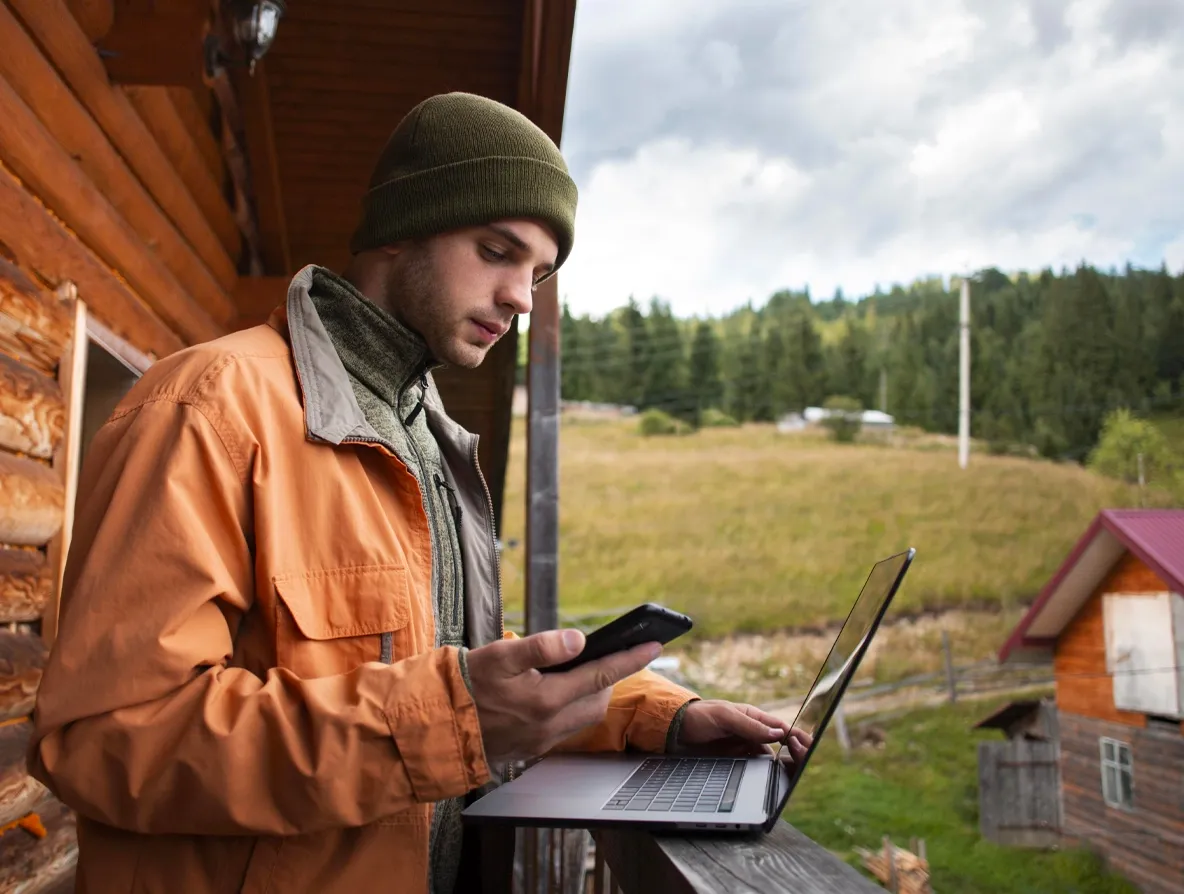 A man receiving internet service in a rural area