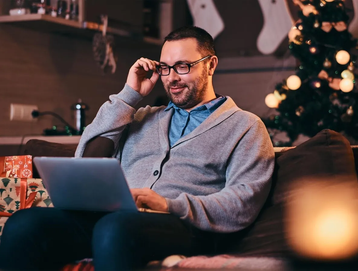 A man watching Christmas Movies on his laptop